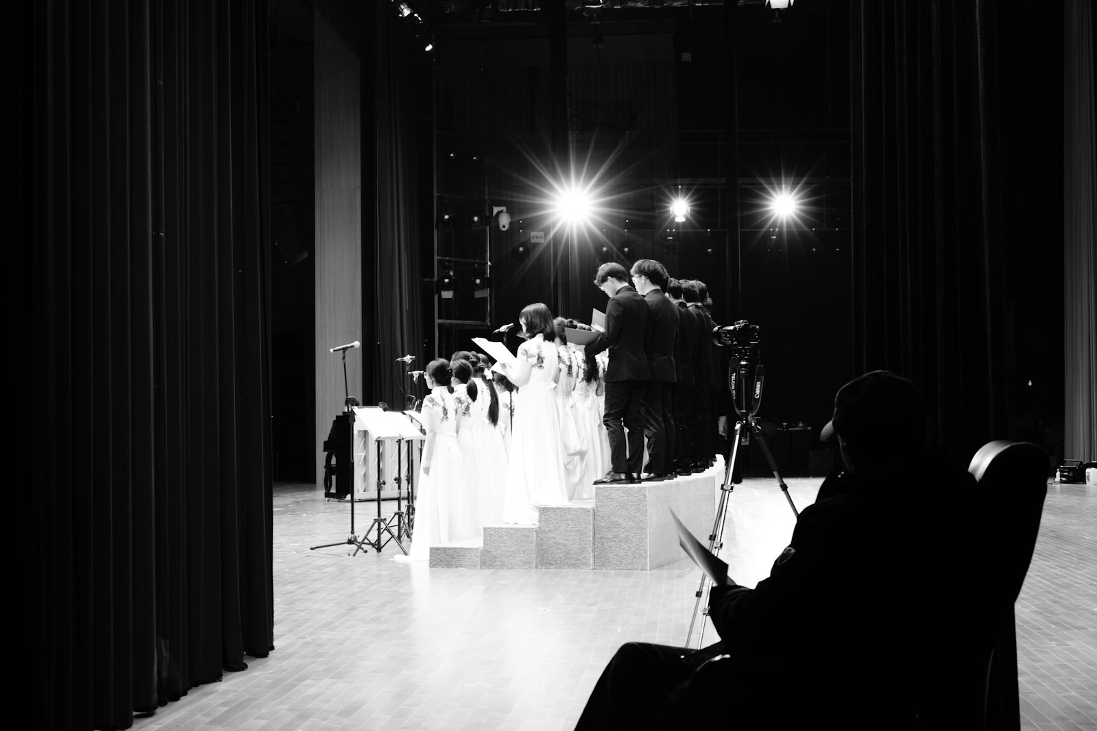 Choir performing on an auditorium stage